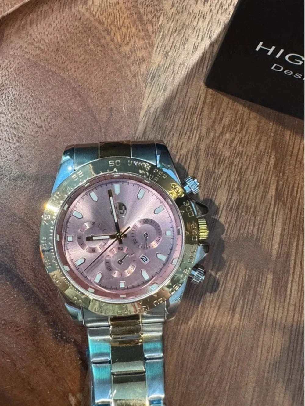 AJ stainless steel watch, pink face, gold & silver toned band